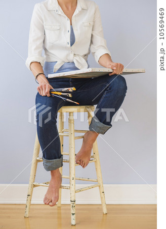 Studio Shot, Low section of woman sitting on stool 10569469