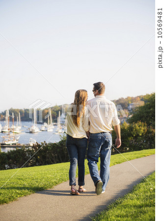 Couple walking with harbor in background 10569481