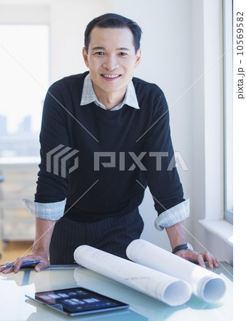 Mid adult architect working in his studio Mid adult architect working in his studio 10569582