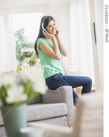 Portrait of woman listening to music on headphones 10569752