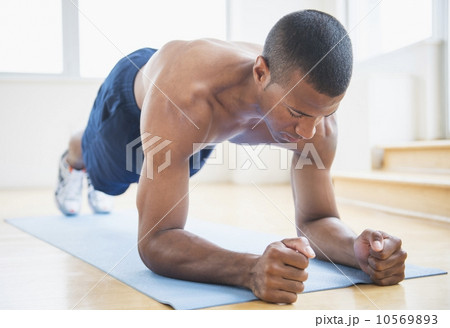 Athletic young man exercising at home Athletic young man exercising at home 10569893
