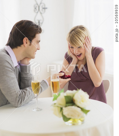 Couple celebrating engagement in restaurant 10569939