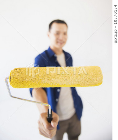 Man holding painting roll Man holding painting roll 10570154