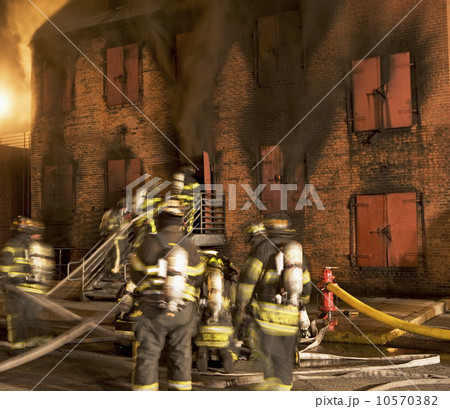 Firefighters at burning building 10570382