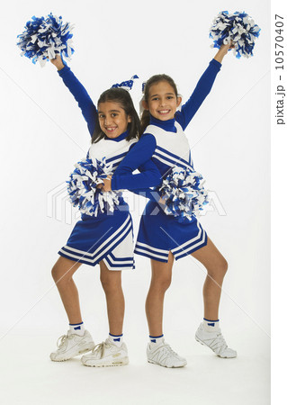 Portrait of cheerleaders (8-9 years) ( 10-11 years) holding pom-pom Portrait of cheerleaders (8-9 years) ( 10-11 years) holding pom-pom 10570407