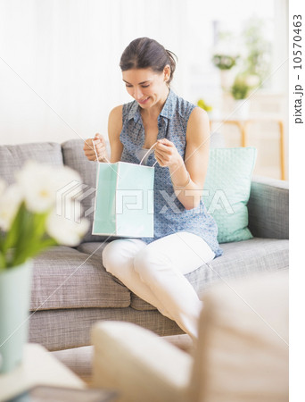 Woman opening gift bag Woman opening gift bag 10570463