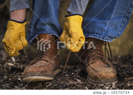 Male tying shoes in protective gloves Male tying shoes in protective gloves 10570734