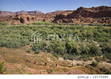 People hiking in canyon, Canyonlands National Park, Moab, Utah, United States People hiking in canyon, Canyonlands National Park, Moab, Utah, United States 10570980