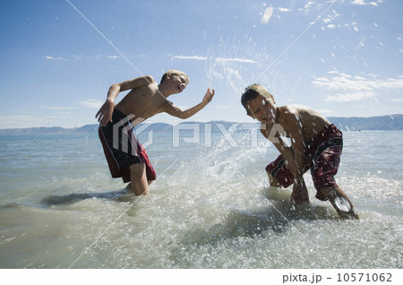 Brothers splashing in lake, Utah, United States Brothers splashing in lake, Utah, United States 10571062