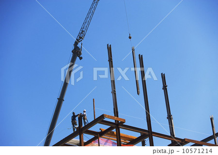 Low angle view of construction workers on beam Low angle view of construction workers on beam 10571214