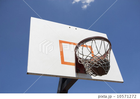 USA, Florida, Miami, Low angle view of basketball hoop with basketball inside 10571272