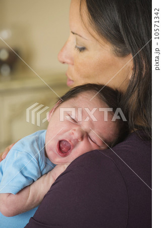 Portrait of mother holding newborn baby (0-11 months) Portrait of mother holding newborn baby (0-11 months) 10571342