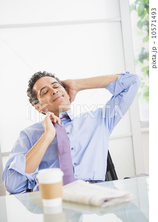 View of mature man relaxing in office View of mature man relaxing in office 10571493