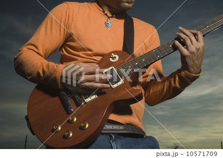 Close up of man playing guitar 10571709