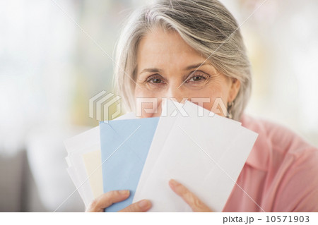 Portrait of woman holding mail 10571903