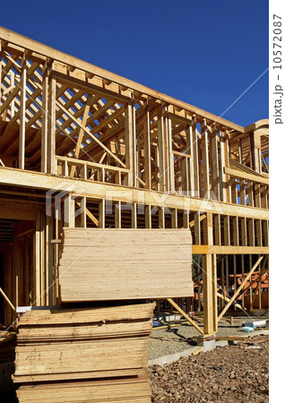 Stacks of plywood in front of house frame 10572087
