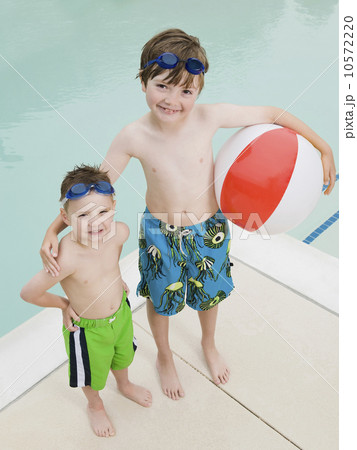 Brothers posing by swimming pool 10572220