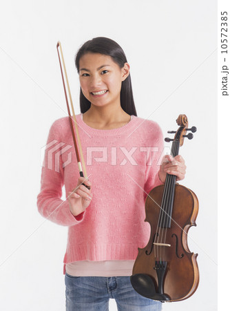 Portrait of teenage girl ( 16-17 years) holding violin Portrait of teenage girl ( 16-17 years) holding violin 10572385