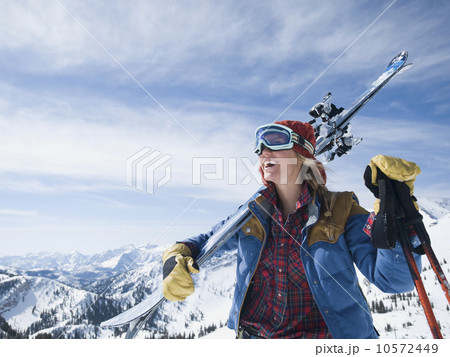 Woman holding skis on shoulder Woman holding skis on shoulder 10572449