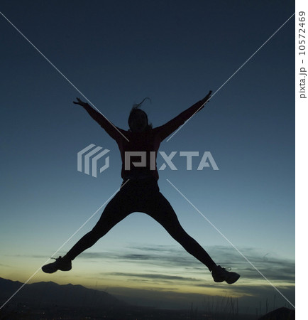 Silhouette of women jumping, Salt Flats, Utah, United States 10572469