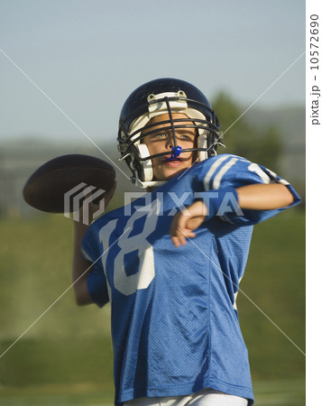 Young football player throwing ball 10572690