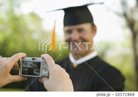 Male graduate having photograph taken 10572868