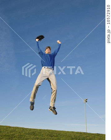 Baseball player jumping in air 10572910