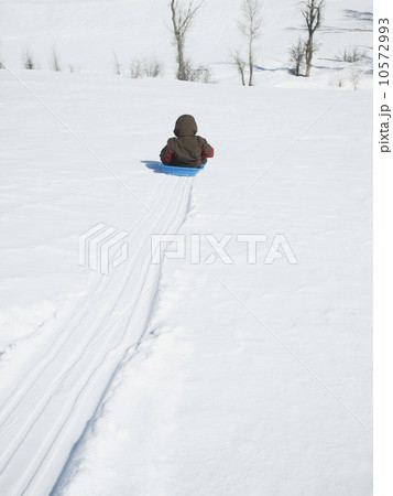 Boy riding on sled Boy riding on sled 10572993