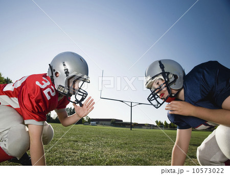 Opposing football players facing at line of scrimmage Opposing football players facing at line of scrimmage 10573022