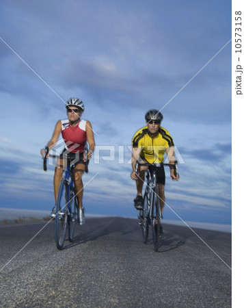 Couple cycling on road, Utah, United States 10573158