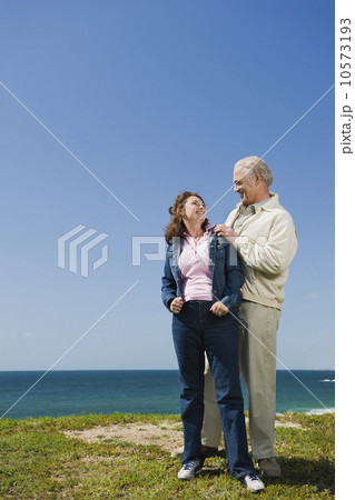 Couple standing near the ocean 10573193