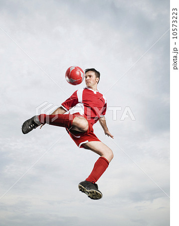 Soccer player kicking soccer ball in mid-air 10573223