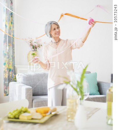 Portrait of woman decorating living room 10573243