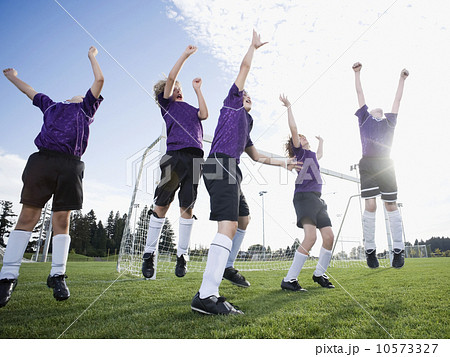 Boys soccer team celebrating on field 10573327