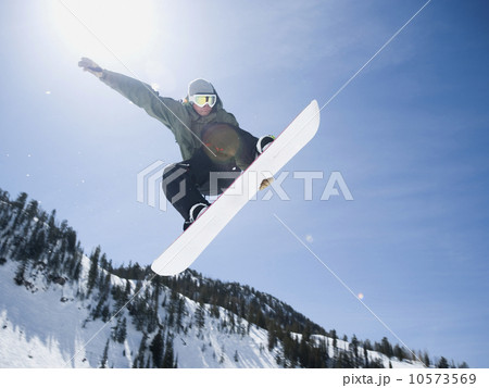 Man on snowboard in air, Wasatch Mountains, Utah, United States Man on snowboard in air, Wasatch Mountains, Utah, United States 10573569