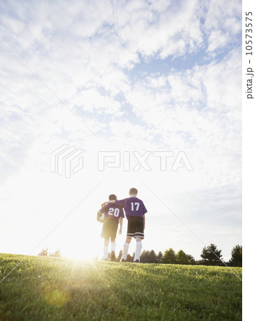 Boys in soccer uniforms walking on field Boys in soccer uniforms walking on field 10573575