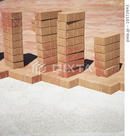 Stacks of bricks on edge of new patio 10573643