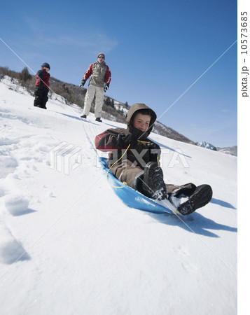 Boy riding on sled Boy riding on sled 10573685