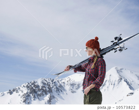 Woman holding skis on shoulder 10573822