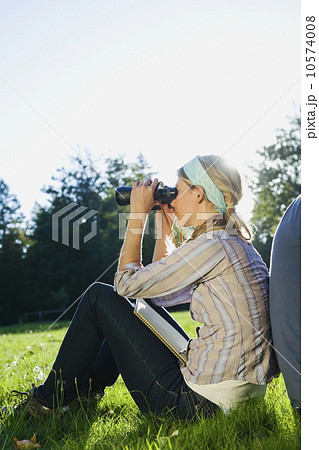 Woman looking through binoculars 10574008