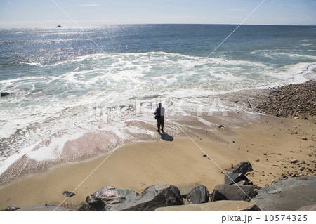 USA, New York, Long Island, Montaurk, Man fishing in sea 10574325