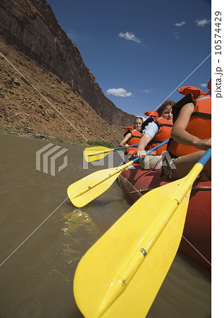 People paddling in raft 10574429