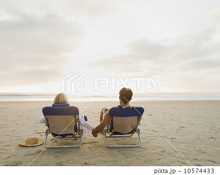 Couple relaxing at the beach Couple relaxing at the beach 10574433