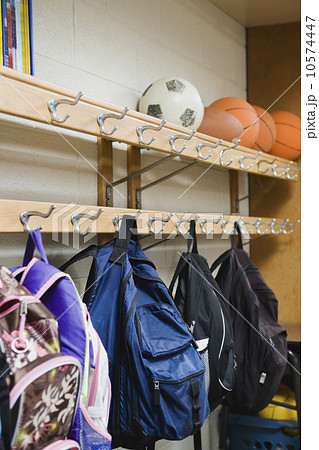 Children's backpacks hanging on hooks in classroom Children's backpacks hanging on hooks in classroom 10574447