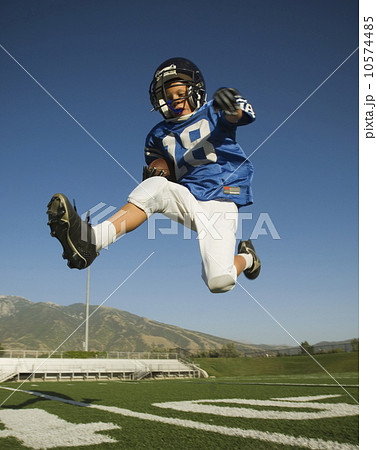 Young football player jumping Young football player jumping 10574485