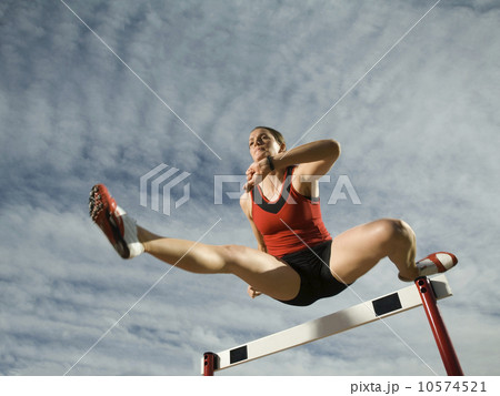 Female athlete jumping hurdle, Utah, United States 10574521