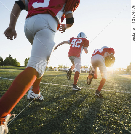 Football players running on field Football players running on field 10574626