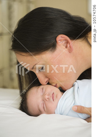 Portrait of mother kissing newborn baby (0-11 months) Portrait of mother kissing newborn baby (0-11 months) 10574706