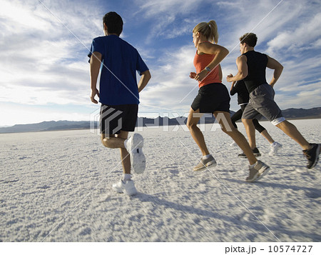 Group of people running on salt flats, Utah, United States Group of people running on salt flats, Utah, United States 10574727