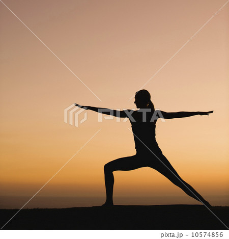 Silhouette of woman doing yoga 10574856